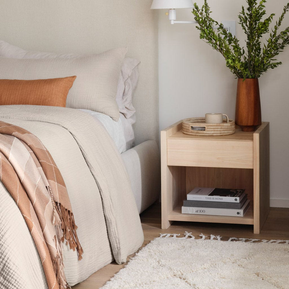 Palm tray sitting on wooden nightstand