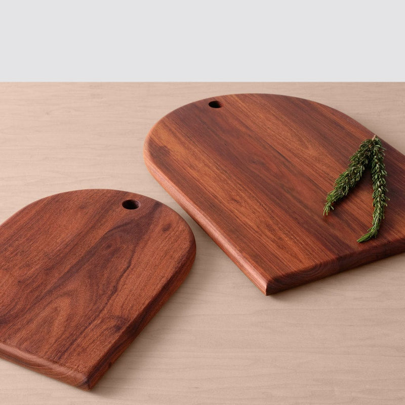 Two granadillo wood serving boards lying on counter, granadillo